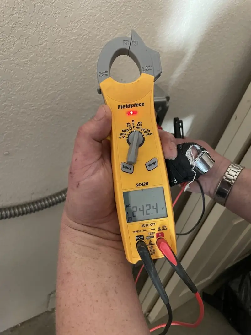 Voltage testing with clamp meter during Ceiling Fan Installation in Lower Grand Lagoon